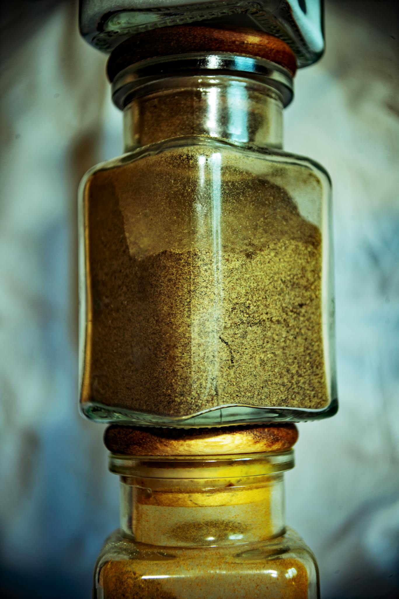 Detailed view of transparent spice jars showcasing various aromatic mixes. Perfect for culinary themes.