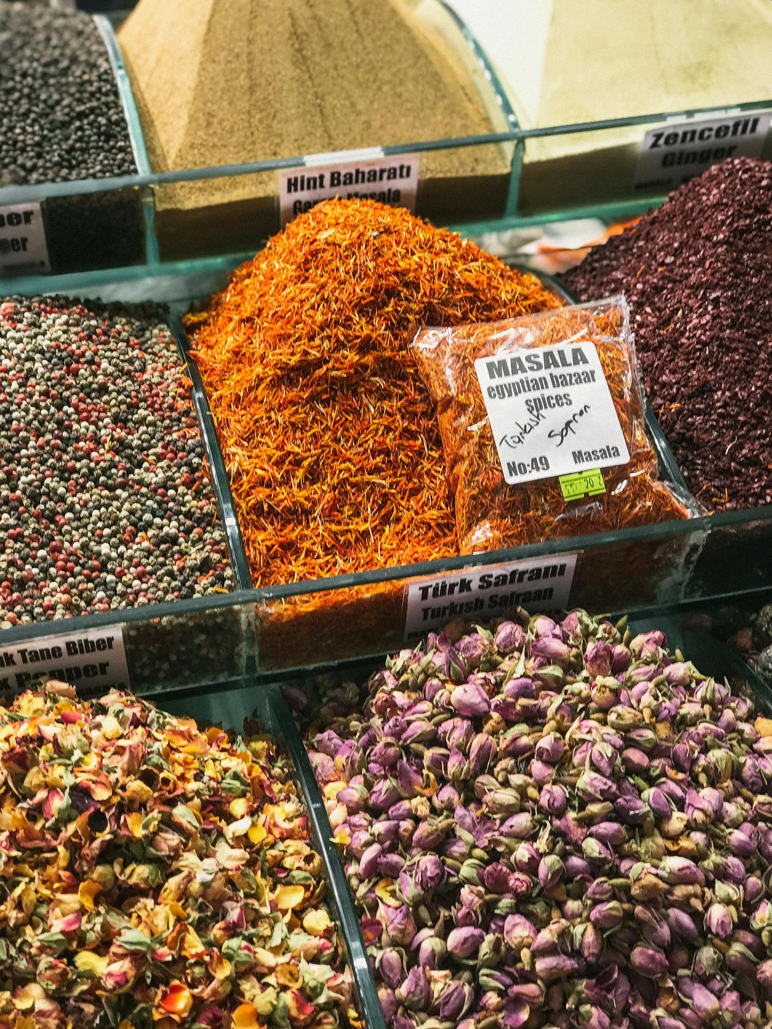 Vibrant assortment of spices and herbs at a market stall, showcasing diversity and culture.